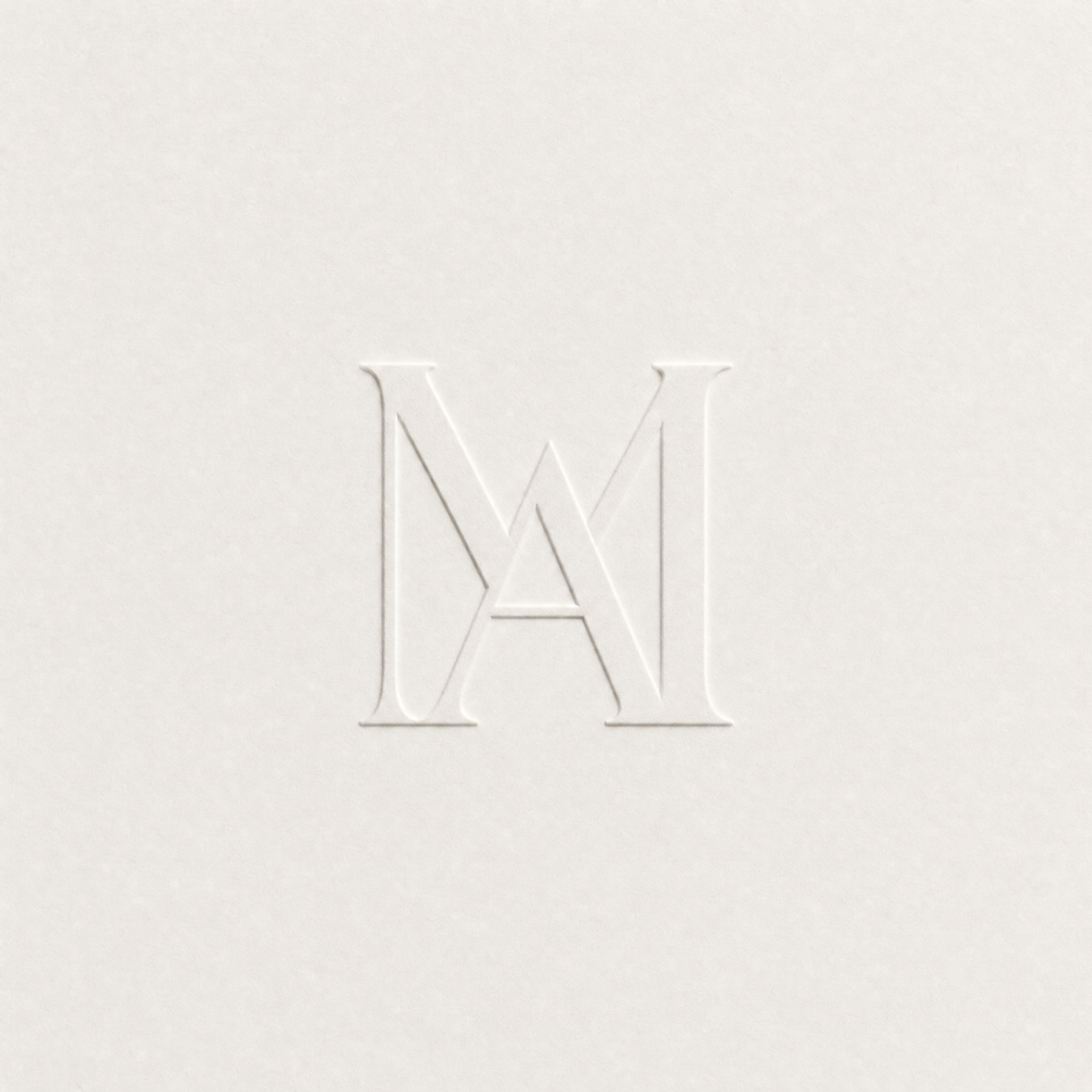 Embossed monogram mark on ivory paper